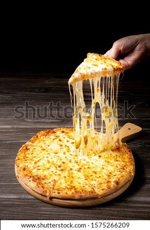 Pizza with very much cheese melting