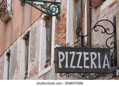 Pizzeria Sign Outside A Local Cozy Restaurant In Venice.