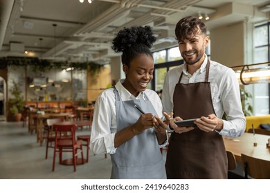 Pizzeria worker standing together and discussing something - Powered by Shutterstock