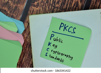 PKCS - Public Key Cryptography Standards Write On Sticky Notes Isolated On Wooden Table.