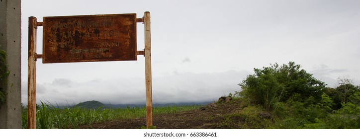 The placard that decayed by the forest.