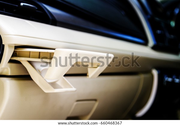 Place of coffee or tea mugs or bottle\
on the vehicle console in modern luxury car\
interior