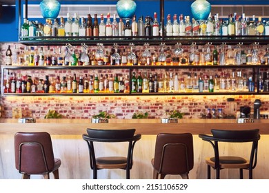 The Place To Go To Have Fun. Shot Of An Immaculate Bar With Many Bottles And Glasses With No People.