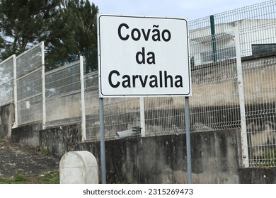 A place name sign for Covao da Carvalha place, Mira de Aire, Porto de Mos, Leiria, Portugal. Traditional black on white name sign.
