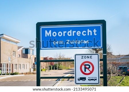 Place name sign of Moordrecht, municipality of Zuidplas, Netherlands. Sign below means that parking is not allowed for trucks and buses in the zone.
