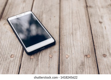 Place The Phone On A Piece Of Wood