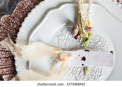 Place setting for Emilia with fine paper and floral arrangement - Shutterstock ID 1373488943