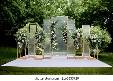 Place For Wedding Ceremony In Garden Outdoors, Copy Space. Wedding Arch Decorated With Flowers. Wedding Setting