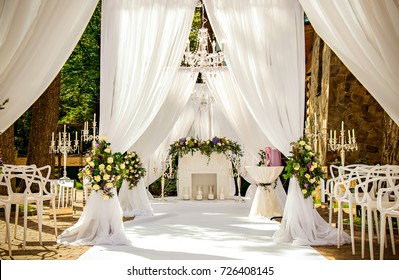 Place for wedding ceremony in white color ,with white fireplace 