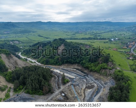The place where the Corund stream eroded the soil and entered the salt mine in Praid - Romania. Aerial view of the hole where the Corund river floods the Praid salt mine
