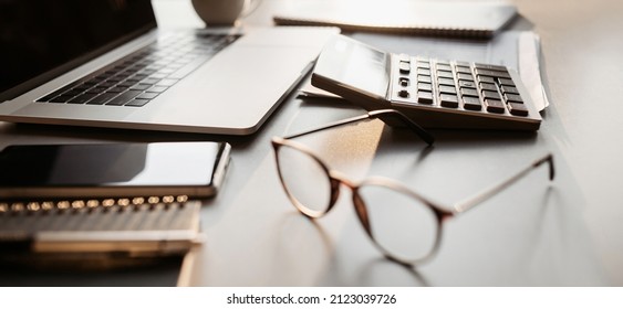 Place Of Work At Home Office, Calculator, Laptop Computer On Desk.