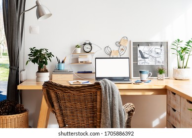 Place for work at home with wooden office desk  and laptop with empty screen with mock up. Home office while coronavirus. Cozy interior in scandinavian style with white wall with copy space. - Powered by Shutterstock