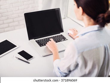 Place Of Work. Young Woman Working In Office. Student Girl Using Laptop Computer At Home. Business, Freelance, Home Work, Online Learning, Studying Concept. Blank Screen Monitor. Distance Education