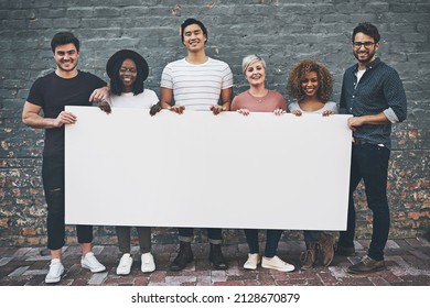 Place Your Words Here And Let It Be Seen. Shot Of A Diverse Group Of People Holding Up A Placard Outside.