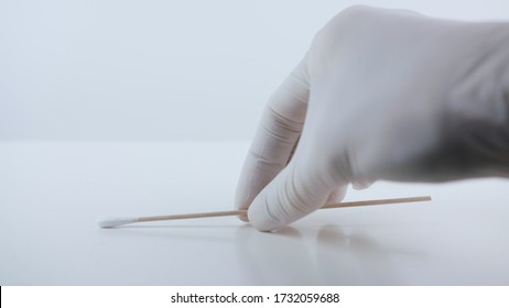 Placeing a swab for covid testing on a white surface. - Shutterstock ID 1732059688