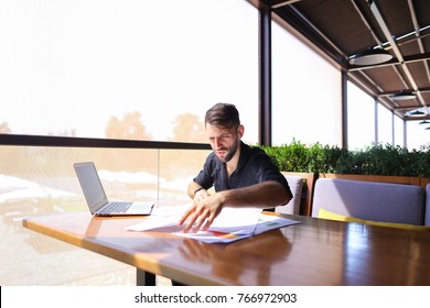 Placeman Sorting Papers On Desk Near Laptop. Strong Male Hands With Watch Near Window. Concept Of Stopping Document Clutter On Workplace.