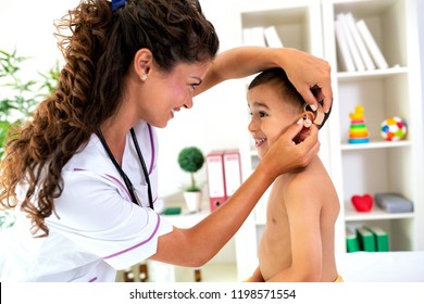 Placement Of The Hearing Aid Medical Device On Child’s Ear Done By His Doctor