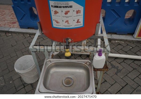 Places to\
wash hands in public places are the implementation of the Covid-19\
health protocol during the pandemic in the city of Medan in North\
Sumatra.  Medan, Indonesia - ca\
2021