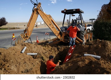 Placing PVC Conduit For Fiber Optic Data Cable In A Trench