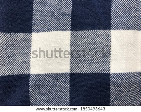 Plaid check patten in dark navy, blue and white. Fabric texture.