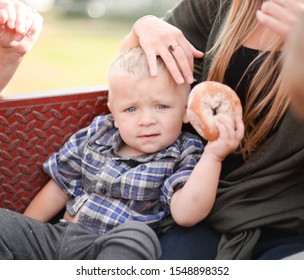 Plaid Farm Boy Holding Apple Cider Doughnut