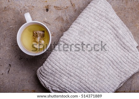 plaid and green tea on a concrete background