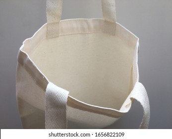 Plain Blank Canvas Bag Hanging On Wall Seeing Inside Of Bag With Space For Logo, Brand Name, Runaround Or Wraparound Text 