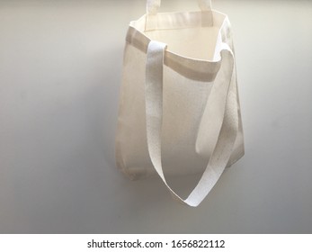 Plain Blank Canvas Bag Hanging On Wall Seeing Inside Of Bag With Space For Logo, Brand Name, Runaround Or Wraparound Text 