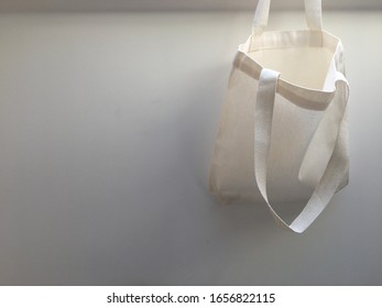 Plain Blank Canvas Bag Hanging On Wall Seeing Inside Of Bag With Space For Logo, Brand Name, Runaround Or Wraparound Text 