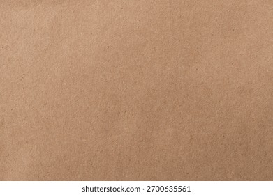 Plain brown surface presents versatile backdrop for arts, crafts, or packaging projects. Ideal for DIY enthusiasts.
