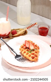 Plain Croissant Waffle or Croffle Served in Pink  Plate with Strawberry and Mint Leaf Topping, with Korean Strawberry Milk 