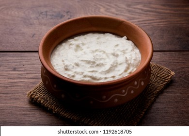 Plain curd or yogurt or Dahi in Hindi, served in a bowl over moody background. Selective focus