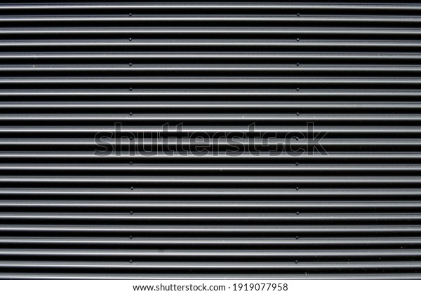 Plain dark corrugated galvanized metal garage door,\
panel or wool