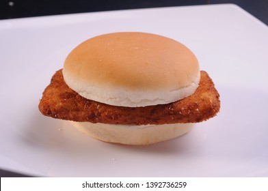 A Plain But Delicious Chicken Burger Served On A White Plate.