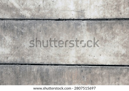 A plain, dull, unpainted wall with a rough texture.
