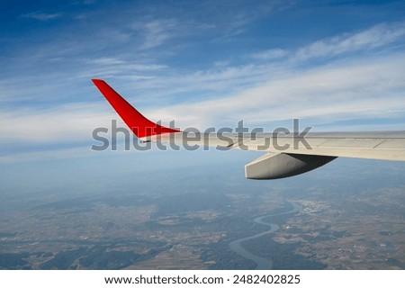 Plain flight. Wing of the plane, under the sky.
