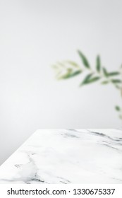 Plain Gray Wall With Leaf And White Marble Table Product Background