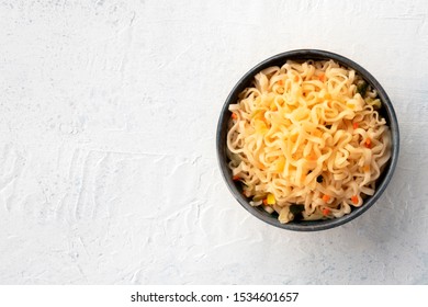 Plain Instant Noodles With Carrot And Scallions, Overhead Shot On A White Background With Copyspace