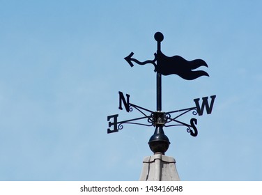 Plain Modern Weathervane On A Roof Top Showing Wind Direction Without A Cockerel