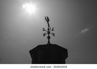 Plain Modern Weathervane On A Roof Top Showing Wind Direction Without A Cockerel