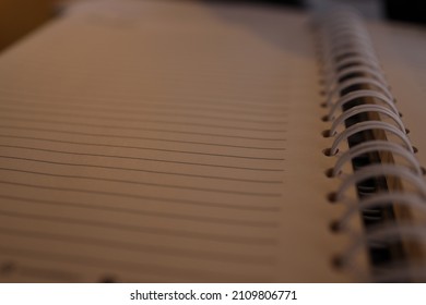 Plain Notebook And Blank Page No Line Paper Lay Flat Focusing On Black Spiral Binding Coil