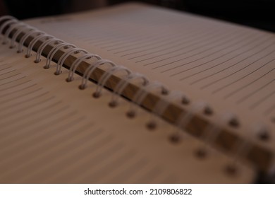 Plain Notebook And Blank Page No Line Paper Lay Flat Focusing On Black Spiral Binding Coil