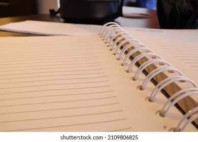 Plain Notebook And Blank Page No Line Paper Lay Flat Focusing On Black Spiral Binding Coil