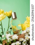 Plain perfume bottle with green background and beautiful yellow, white flowers on wood cutout. depicts fresh and natural floral scent