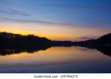 Plain river in the fall after sunset.
The warm tones of light and the smooth flow of water in the river have a calming effect.