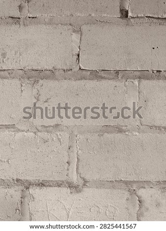 A plain, unpainted cinder block wall with visible mortar lines, presenting a simple, functional, and rugged industrial texture.