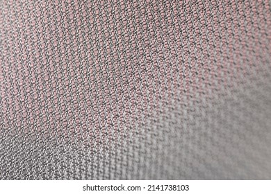 Plain weave of a silver shiny fabric, close up detail shot of a manufactured textile showing the pattern of the weft. Future fashion, material trend