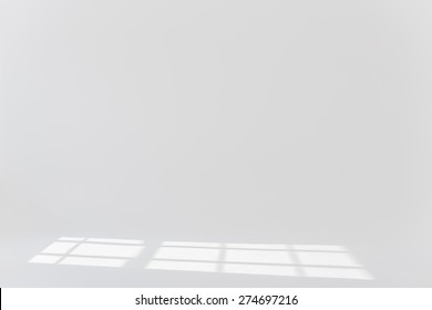 Plain white background with sun light and shadows 