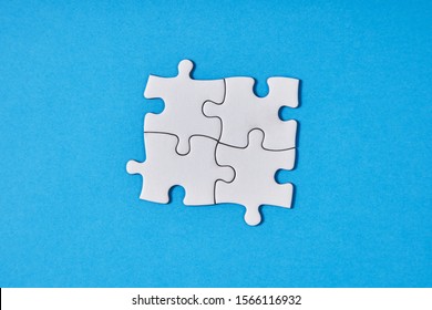 Plain White Jigsaw Puzzle, On Blue Background.business, Teamwork And Collaboration Concept