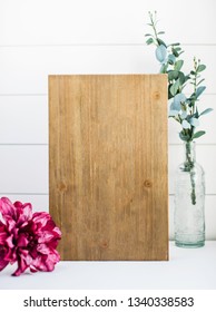 Plain Wood Sign On Shiplap Background With Vintage Bottle, Eucalyptus And Pink Flower Accents Mockup 